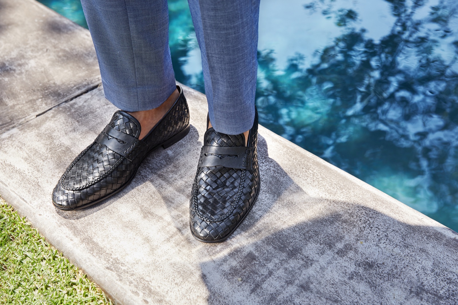 Woven loafers styled beside a pool